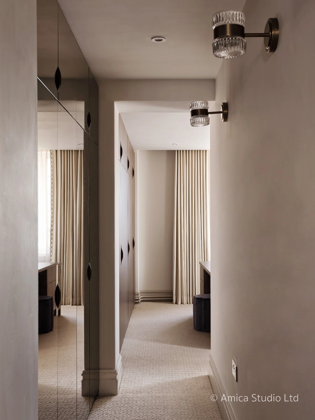 Chelsea Penthouse dressing room with dark cabinetry and crystal wall sconces