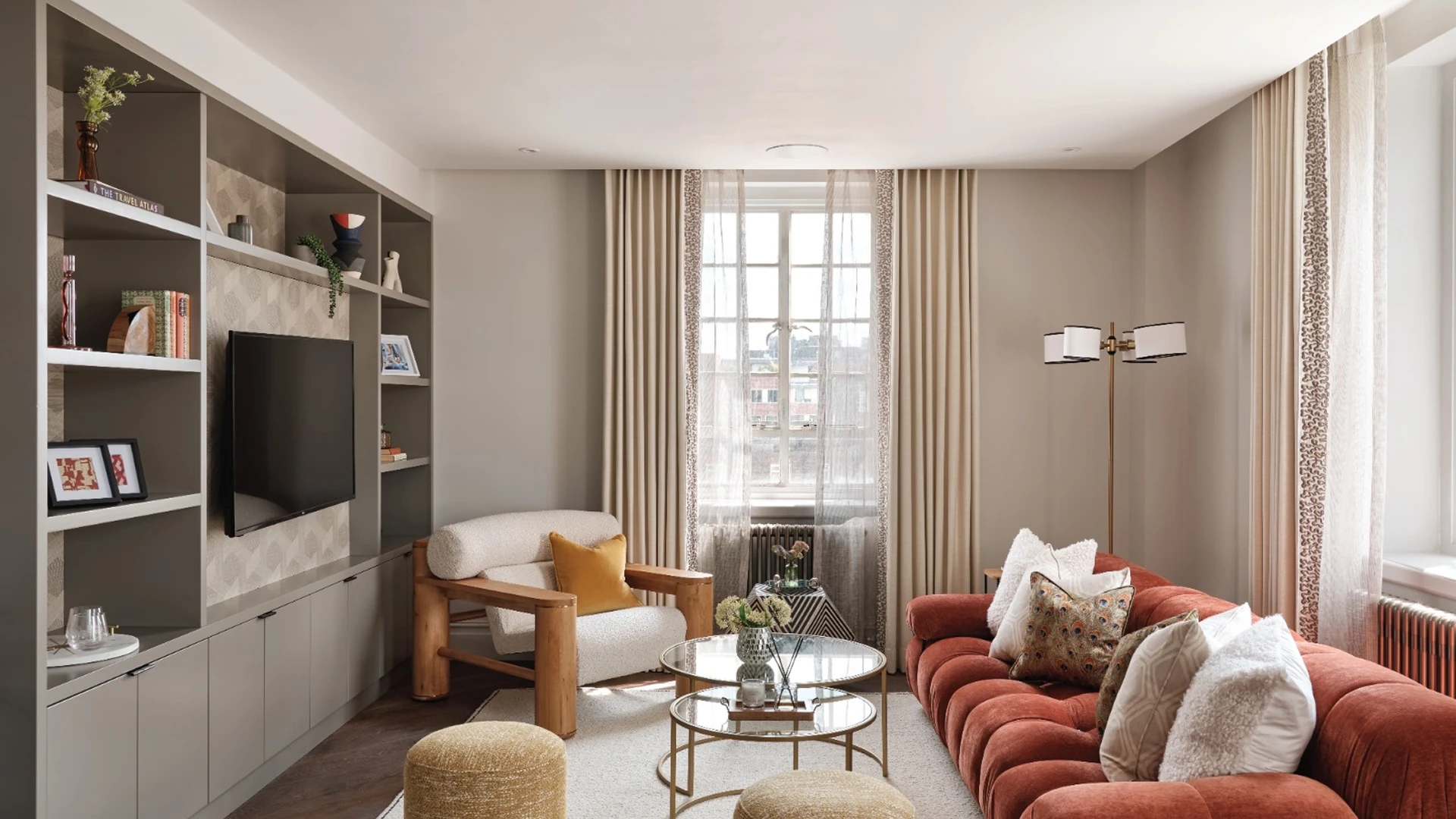 Sophisticated living room with built-in shelving and velvet sofa